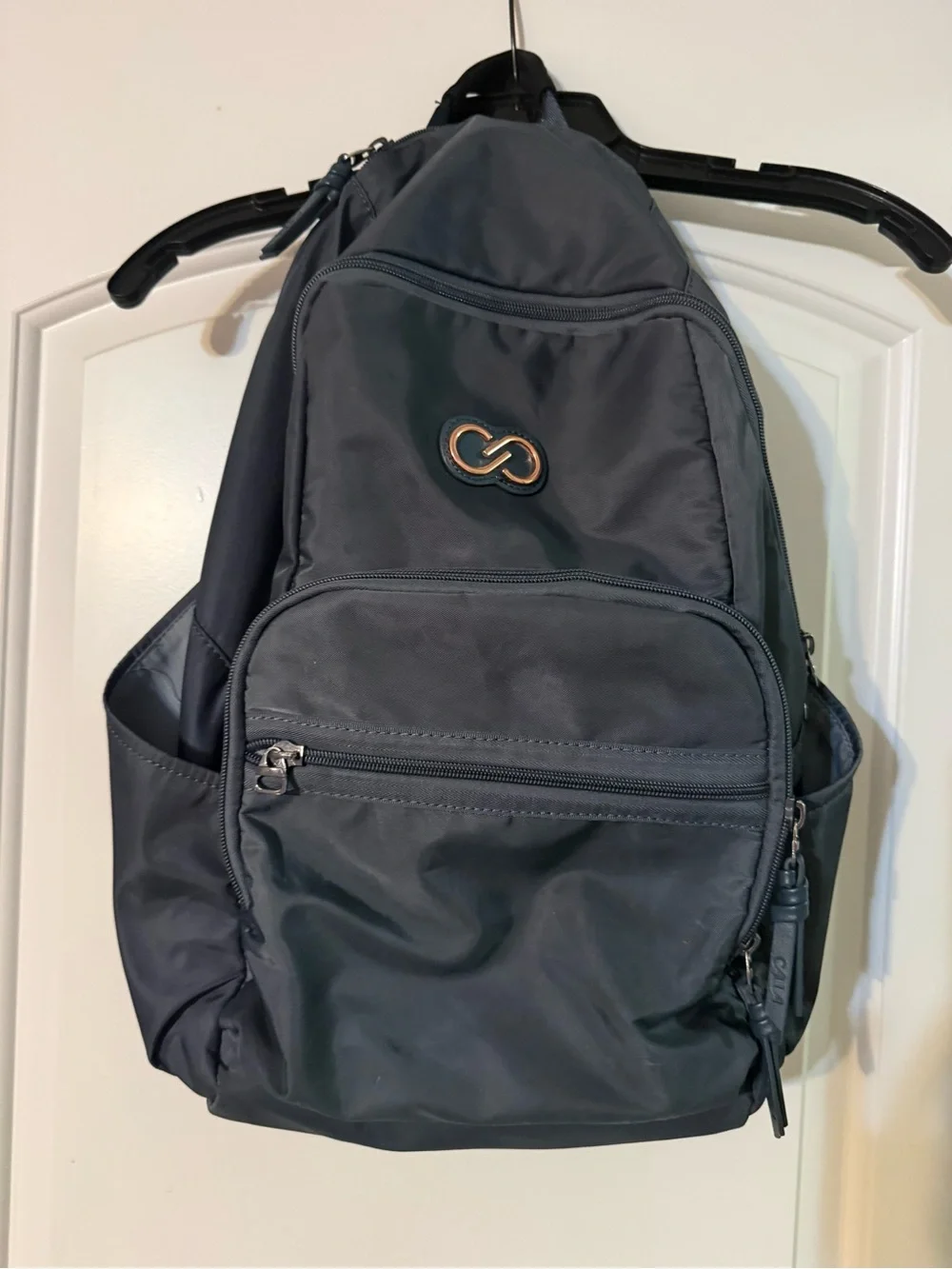 CALIA by Carrie Underwood Black Sling Backpack with Rose Gold Accent
